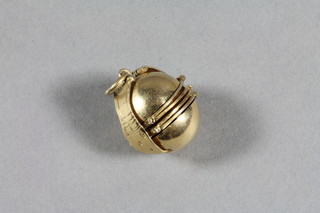 A Mexican yellow metal sphere shaped pendant locket