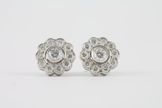 A pair of 18ct white gold cluster earrings, approx 1.10ct