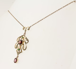 An Edwardian 9ct gold pendant set demi-pearls, garnet and  peridot hung on a fine chain