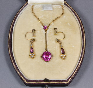 A near matched suite of gold and amethyst set jewellery  comprising a pendant hung on a fine chain and a pair of drop earrings set amethyst and pearls  ILLUSTRATED