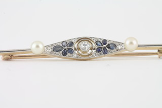 A gold bar brooch set a diamond, sapphire and 2 pearls