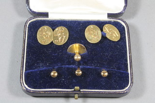 A pair of 18ct gold oval cufflinks 7.7 grams together 4 15ct gold studs 5.2 grams, cased