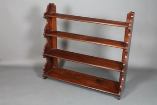 A set of Victorian walnut cascading hanging shelves, having shaped ends supporting 4 shelves, 41.5"h x 44"w x 12"d