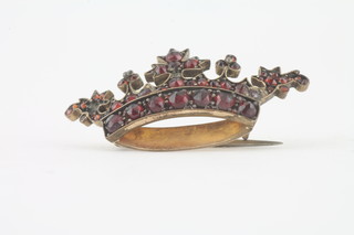 A yellow metal brooch in the form of a coronet set garnets