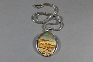 An oval landscape agate pendant set a silver mount hung on a  fine silver chain