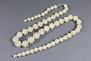 A string of carved ivory beads