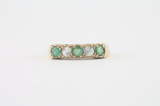 A 9ct gold dress ring set emeralds and diamonds