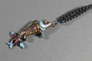 A Hematite bead necklace together with an articulated fish