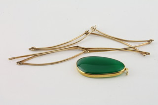 A modern 9ct gold necklet - 10 grams, an oval green polished hardstone pendant in a 9ct gold mount