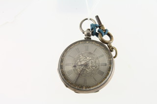 An open faced fob watch contained in a Continental engraved silver case