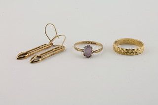 An 18ct gold wedding band 3.3 grams, a 9ct gold dress ring set a pink oval stone and a pair of pierced earrings