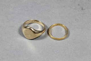 A 22ct gold wedding band together with a 9ct gold signet ring