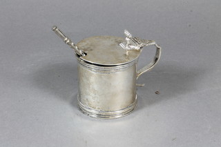 A cylindrical silver mustard pot with blue glass liner, London 1911, 4 ozs