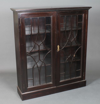 An early 20th Century mahogany bookcase, the moulded top with  egg and dart decoration above a pair of bar glazed doors  enclosing 3 adjustable shelves, raised on plinth base 50"h x 44"w  x 12"d