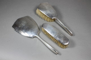 A silver backed 3 piece dressing table set