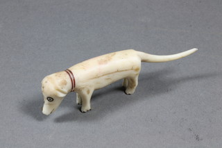 A humorous carved ivory figure of a dog 3.5"