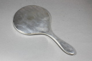 A silver backed hand mirror