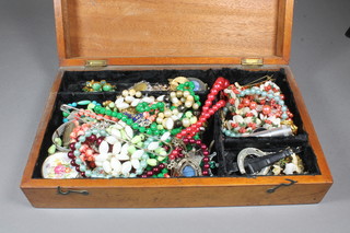 A collection of costume jewellery in a mahogany box with hinged  lid