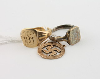 A 9ct gold signet ring and 1 other, a gold Swastika charm
