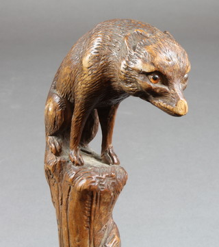 An umbrella with carved wooden handle in the form of a seated  fox