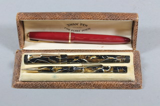 A red Parker Senior Duofold fountain pen and a Swan leverless fountain pen with marbled effect case and matching propelling  pencil
