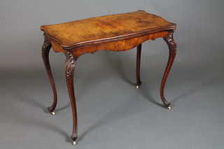 A mid 19th Century French burr and figured walnut card table of serpentine form, the hinged top enclosing a baise lined interior,  raised on acanthus leaf and cabouchon carved cabriole legs,  casters, 29"h x 37"w x 40"d  ILLUSTRATED