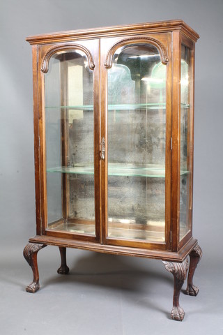 A Victorian mahogany display cabinet fitted adjustable shelves enclosed by arched bevelled plate doors, raised on cabriole ball  and claw supports 67"h x 41.5"w x 16"d