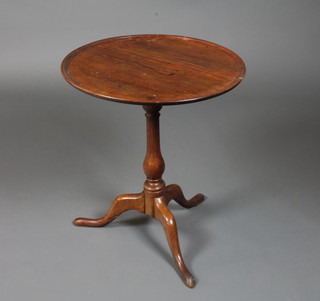 An early 19th Century mahogany and fruitwood tilt top  occasional table with baluster turned column support, tripod base  with slipper feet 26.5"h x 22.5" diam.