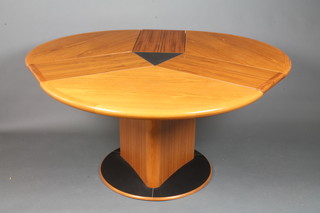 Skovby of Denmark, a modernist rosewood and teak extending  dining table of trefoil form, raised on a parcel ebonised circular  plinth base, 28"h x 58"w