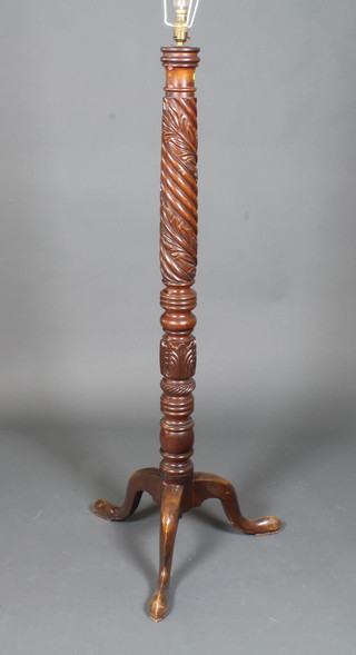 A 19th Century style carved mahogany standard lamp, the  column of spiral form, carved with acanthus leaves, raised on a  tripod base with slipper feet 54"h