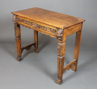 A 19th Century Flemish carved oak side table fitted a foliate  carved frieze drawer raised on carved tapered legs, block feet,  31"h x 36"w x 18"d