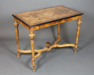 A mid 19th Century French walnut centre table, boxwood line inlaid, crossbanded and parcel ebonised, having a quarter  veneered top, raised on turned tapered legs united by a shaped  stretcher 30"h x 39"w x 23"d