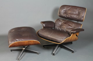 Charles & Ray Eames for Herman Miller, a lounge chair model  670 and matching ottoman model 671, having dark brown leather  piped upholstery and rosewood veneered frames, both bear  Herman Miller label to bases  ILLUSTRATED