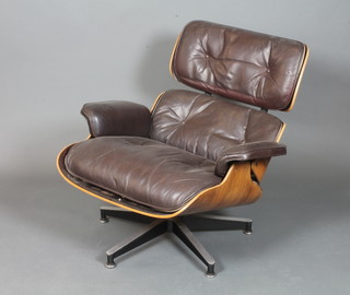 Charles & Ray Eames for Herman Miller, a lounge chair model  670 with dark brown leather piped upholstery and rosewood veneered frame, bears Herman Miller label to base
