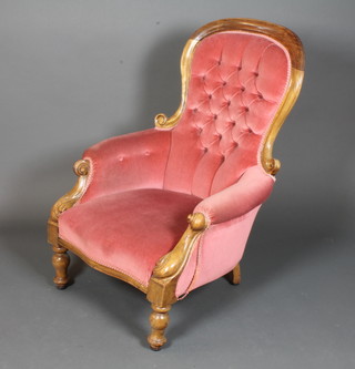 A Victorian stained beechwood open arm chair having pink  Dralon upholstery, raised on baluster turned legs