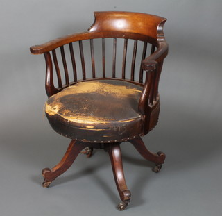 A Victorian mahogany swivel desk chair with horseshoe arms  over a rexine seat on quadripartite swivel base