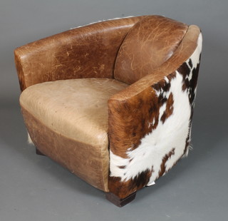In the style of Carlo Bugatti, an unusual cow hide open arm chair  on block feet