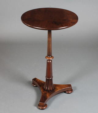 An early Victorian mahogany wine table with circular top, raised  on a reeded knopped column support, triform base with flattened  bun feet 28"h x 16.5" diam.