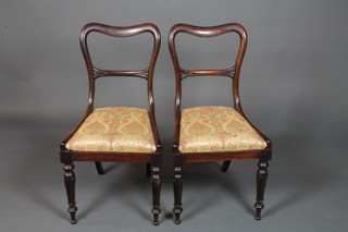 A pair of William IV rosewood buckle back dining chairs, the Trafalgar seats with paisley woven upholstery, raised on lapit  carved turned and tapered legs