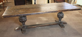 A 19th Century Northern European oak refectory dining table in  the 17th Century style, the rectangular top supported by massive  cup and cover supports with vineous relief carved decoration,  united by an H stretcher 31"h x 40"d x 96"l