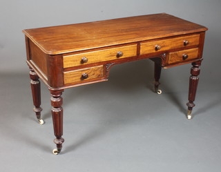 Edwards & Roberts, a Victorian mahogany writing table fitted with an arrangement of 4 drawers, raised on turned reeded  tapered legs with brass caps and casters 29"h x 49"w x 21.5"d