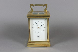 An early 20th Century lacquered brass repeating carriage clock,  having Roman enamelled dial and Arabic alarm dial, the platform  movement chiming gong, 7.5"h x 4"w x 3.5"d