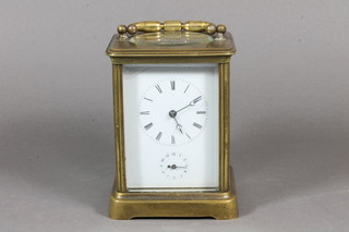 An early 20th Century French lacquered brass corniche cased  carriage clock, having Roman dial and Arabic alarm dial, the  platform escapement striking bell, 7"h x 4"w x 3.5"d