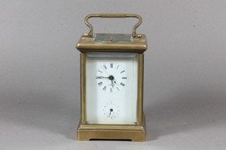 A 20th Century gilt brass repeating carriage clock with Roman  and Arabic enamelled dials, the platform escapement striking  bell, 7.75"h x 4"w x 3.5"d