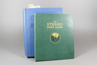 A blue Stanley Gibbons Swiftsure album and a green Standard  album of stamps