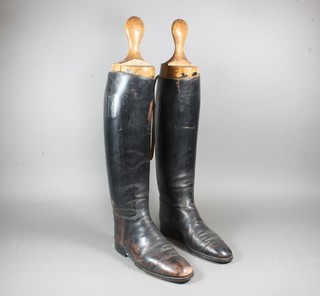 A pair of black leather riding boots complete with wooden trees