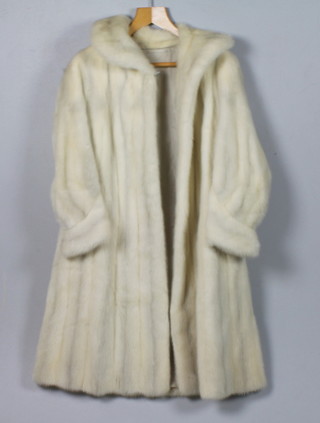 A lady's white full length fur coat retailed by Harrods