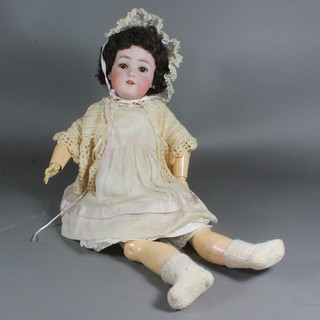 A Simon Halbig porcelain headed doll with opening and shutting  eyes