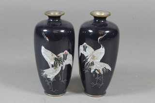 A pair of Japanese black ground ovoid cloisonne vases decorated  cranes 5"