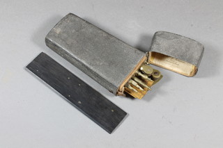 A Victorian brass geometry set contained in a wedge shaped grey skin covered case